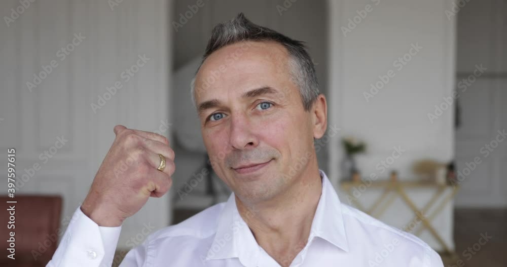 the face of a grown man who shows two fingers up the face of a grown man who shows two fingers up