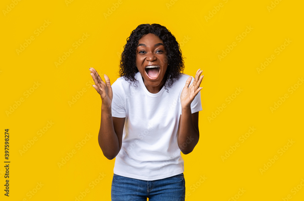 Excited black lady raising hands and yelling Excited black lady raising hands and yelling