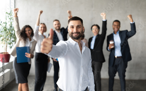 Arab Businessman Gesturing Thumbs Up Standing With Employees In Office