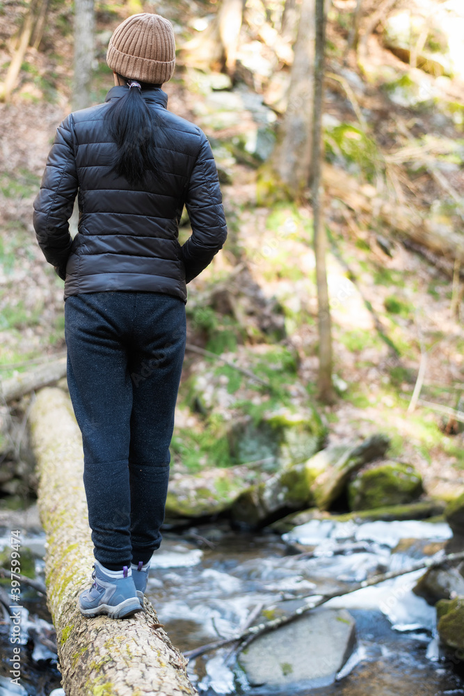 woman on log Deans Ravine new england woman on log Deans Ravine new england