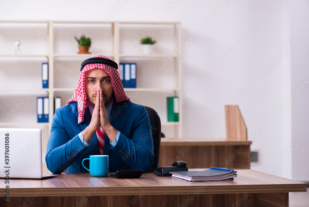 Young male arab employee working in office Young male arab employee working in office