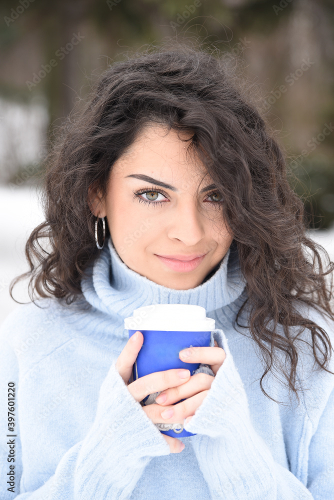 A beautiful young girl with a coffee