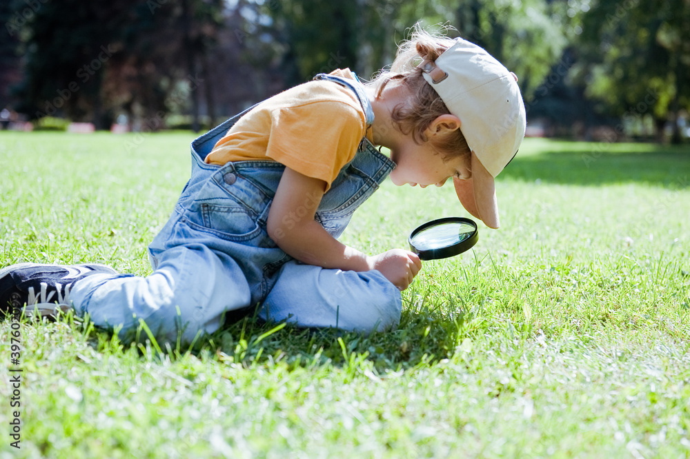 Cute preschooler boy with magnifying glass. Cute preschooler boy with magnifying glass.