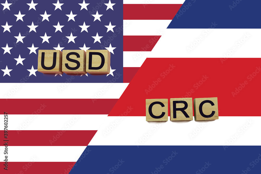 USA and Costa Rica currencies codes on national flags background USA and Costa Rica currencies codes on national flags background