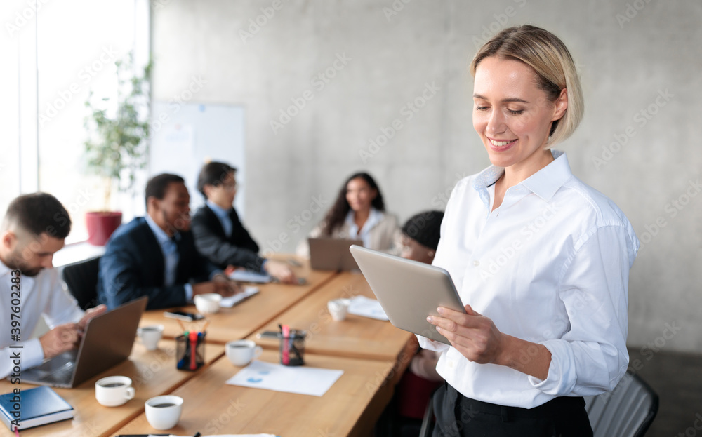 Happy Businesswoman Using Digital Tablet Computer Standing In Modern Office Happy Businesswoman Using Digital Tablet Computer Standing In Modern Office
