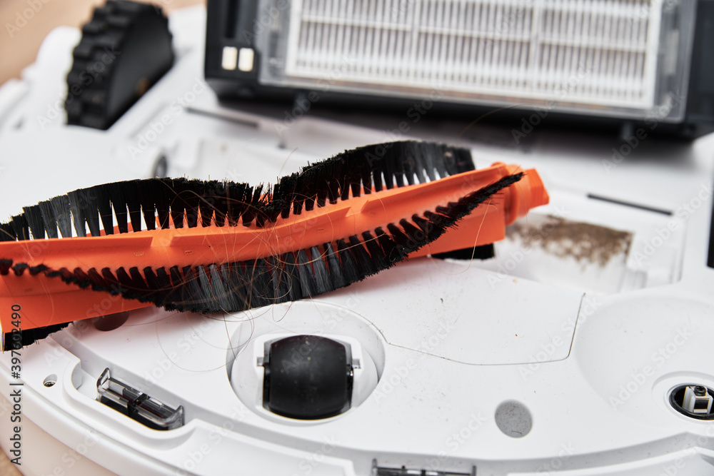 Repair robot vacuum cleaner, closeup. Household appliance service Repair robot vacuum cleaner, closeup. Household appliance service
