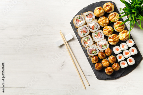 Sushi rolls set on a stone Board for sushi on a light background
