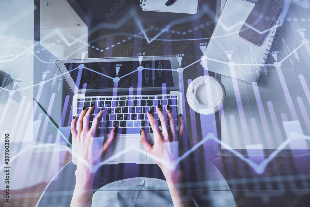 Double exposure of woman hands working on computer and forex chart hologram drawing. Top View. Financial analysis concept. Double exposure of woman hands working on computer and forex chart hologram drawing. Top View. Financial analysis concept.