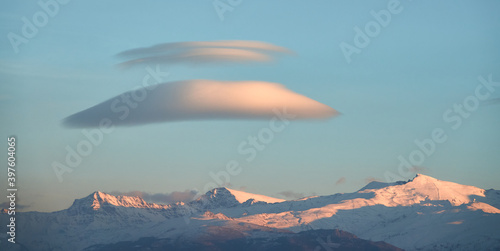 Large white lenticular clouds over Sierra Nevada (Spain) at sunset