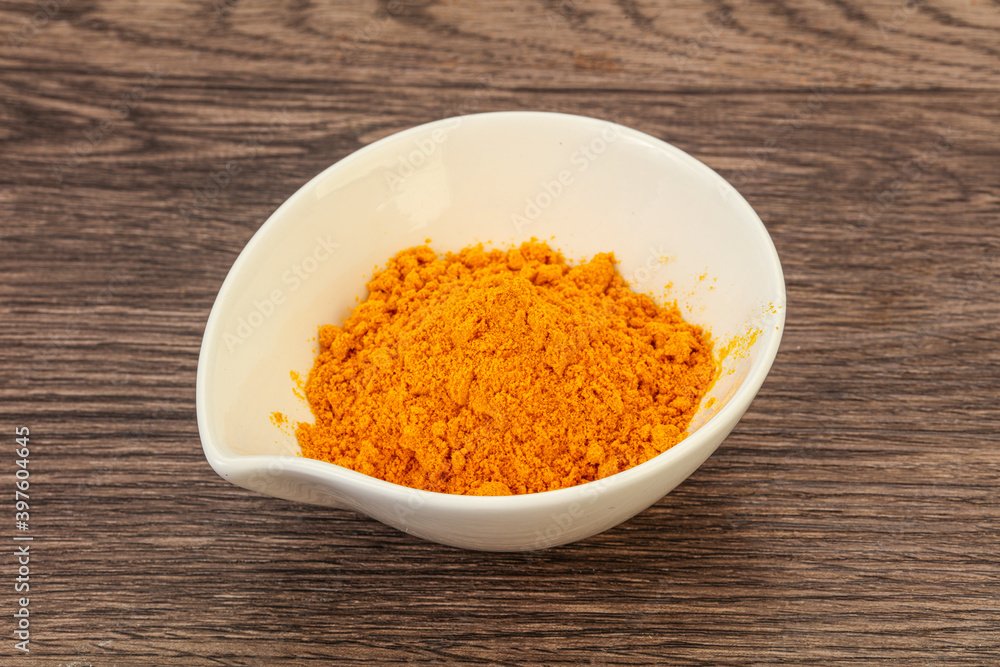 Tumeric powder in the bowl Tumeric powder in the bowl
