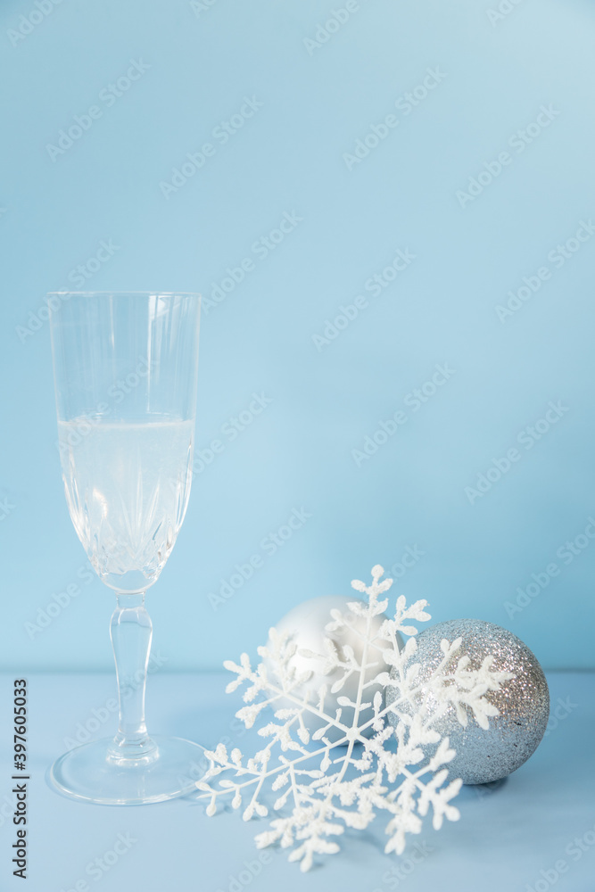 Christmas still life with a glass of  champagne and pine balls.