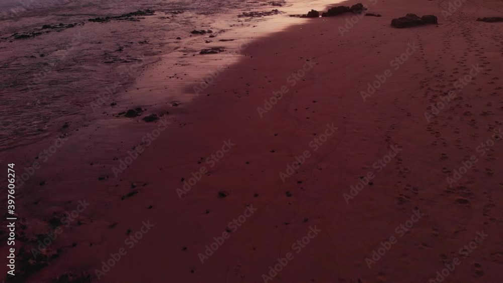 Drone tilts up into the horizon of Calheta red golden sunset . Drone tilts up into the horizon of Calheta red golden sunset .
