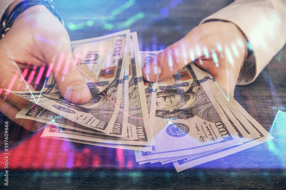 Multi exposure of financial graph drawing hologram and USA dollars bills and man hands. Analysis concept. Multi exposure of financial graph drawing hologram and USA dollars bills and man hands. Analysis concept.