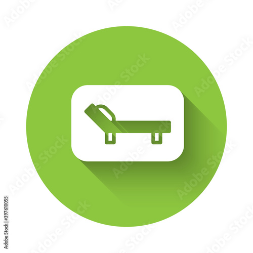 White Sunbed icon isolated with long shadow. Sun lounger. Green circle button. Vector.