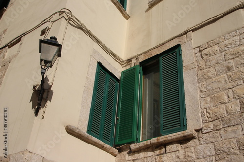 Close up of a greem coloured window and a latern in Bisceglie, Italy