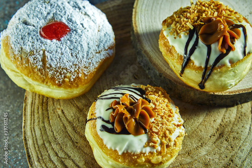 Happy Hanukkah and Hanukkah Sameach is a traditional Jewish donuts with Dulce de Leche, chocolate and powdered sugar. photo