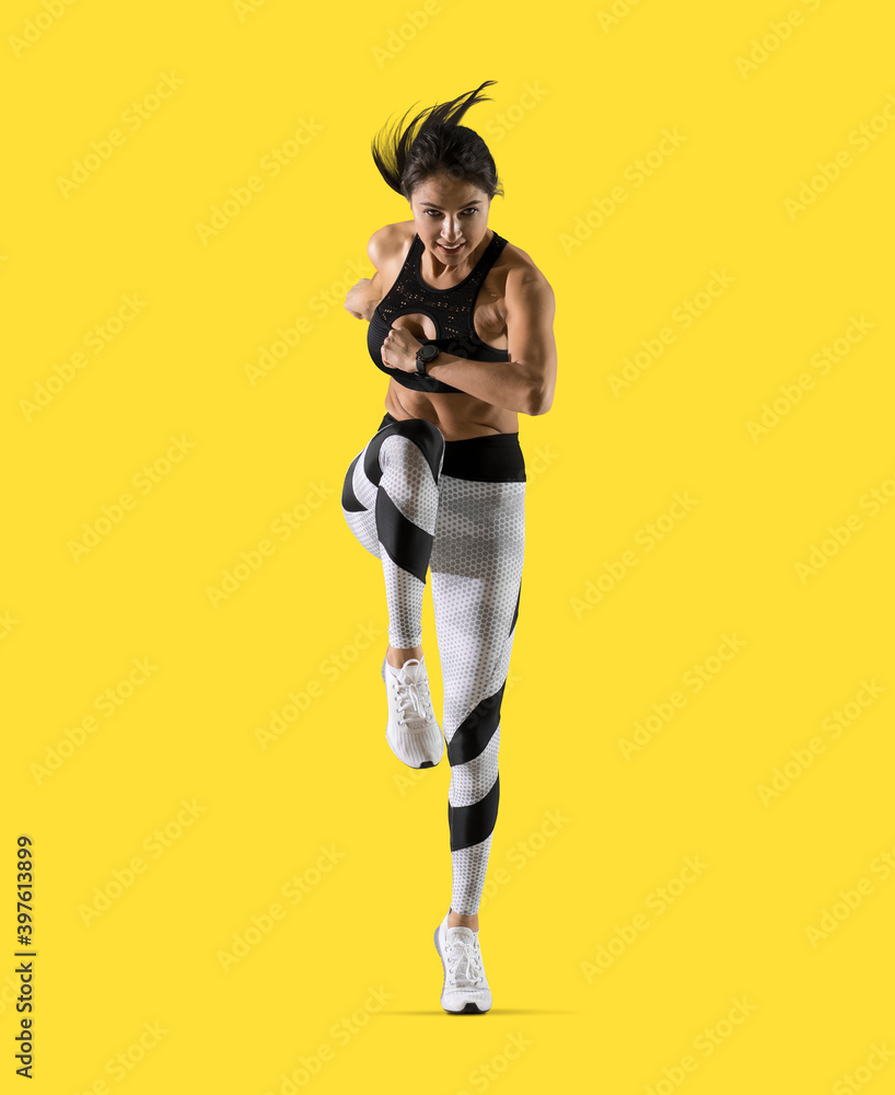 Sporty woman running on isolated on yellow background Sporty woman running on isolated on yellow background