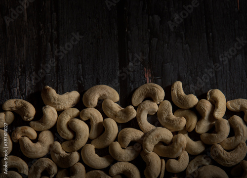 cashew nuts on dark wooden table