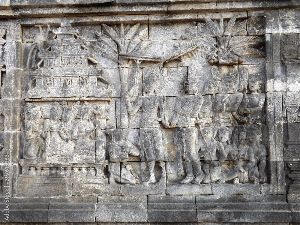 Relief panel of Borobudur temple telling about life in that era. Candi Borobudur is the largest Buddha temple located in Magelang, Central Java, Indonesia. 