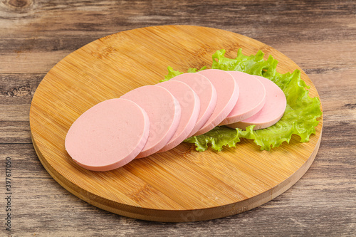 Sliced sausage snak over board