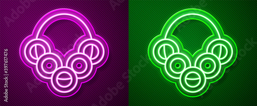 Glowing neon line Russian bagels on a rope icon isolated on purple and green background. Vector.
