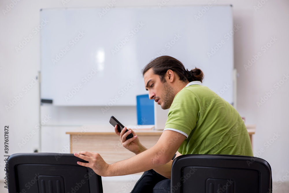 Young male student in business presentation concept Young male student in business presentation concept
