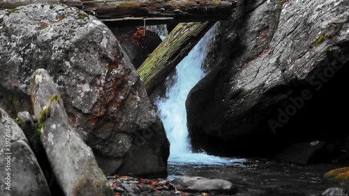 Amazing mountain cascade flowing through the rocks in autumn time