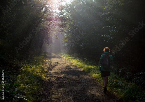 a tourist walking along the trail during sunrise in the Bieszczady Mountains during autumn