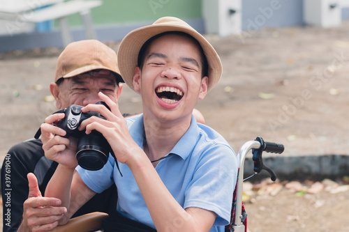 Disabled child on wheelchair is smiling,playing,learning in the outdoor park activity like other people,Lifestyle of special child, Life in the education age of children, Happy disability kid concept.