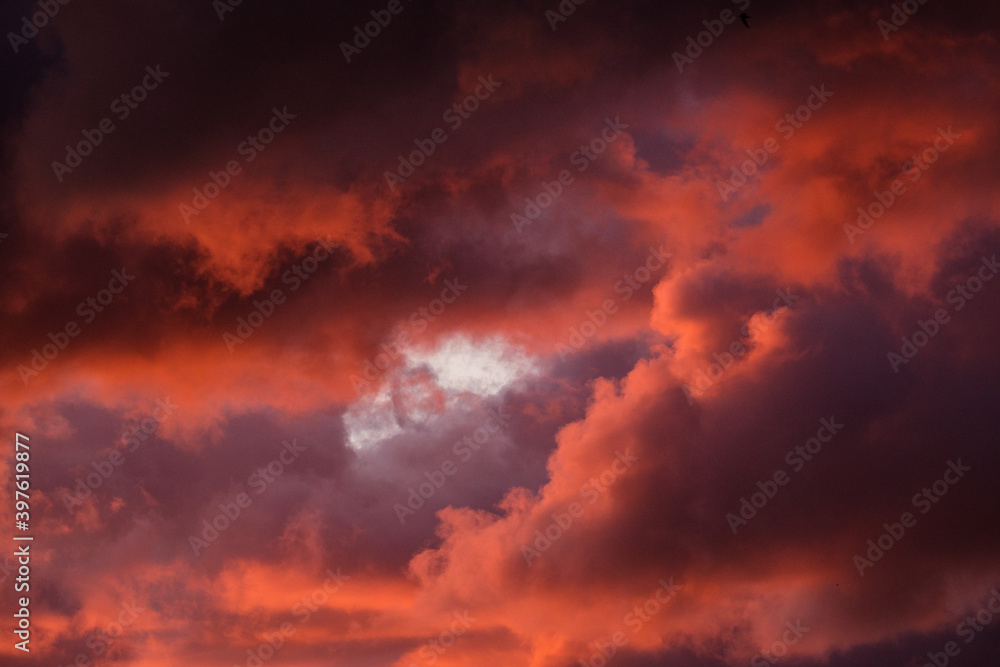 dramatatic red dark sunset over the fields and cities