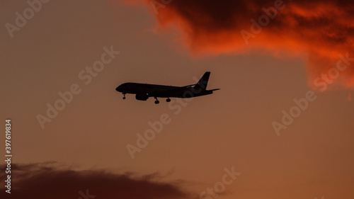 dramatatic red dark sunset over the fields and cities photo