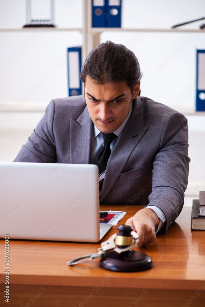 Young male lawyer sitting in the office Young male lawyer sitting in the office