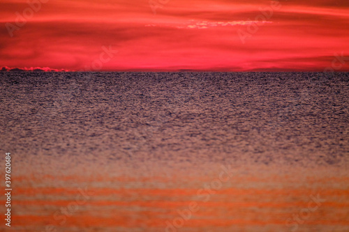 dramatatic red dark sunset over the fields and cities photo