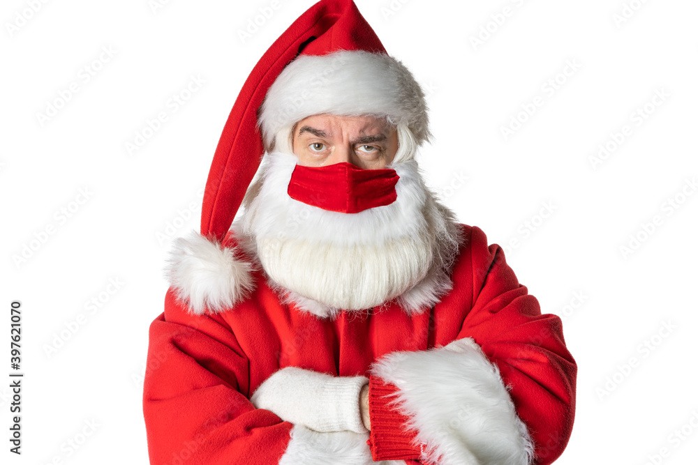 A business man with a beard dressed in a Santa Claus costume, with a mask. Looks ahead carefully. On a white background. A business man with a beard dressed in a Santa Claus costume, with a mask. Looks ahead carefully. On a white background.