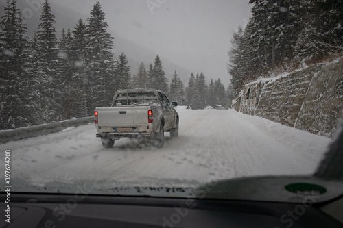 Dangerous overtaking on snowy slippery road by an SUV od pick up vehicle. SUV owners think they own the road.