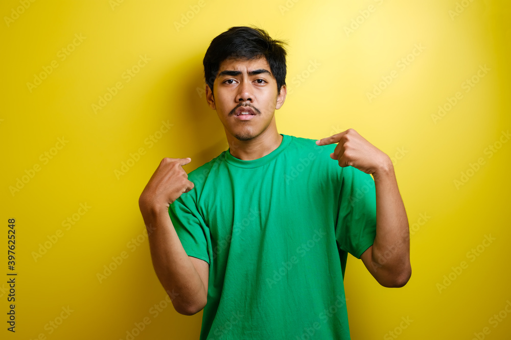 Asian young man pointing at himself wow shock reaction Asian young man pointing at himself wow shock reaction