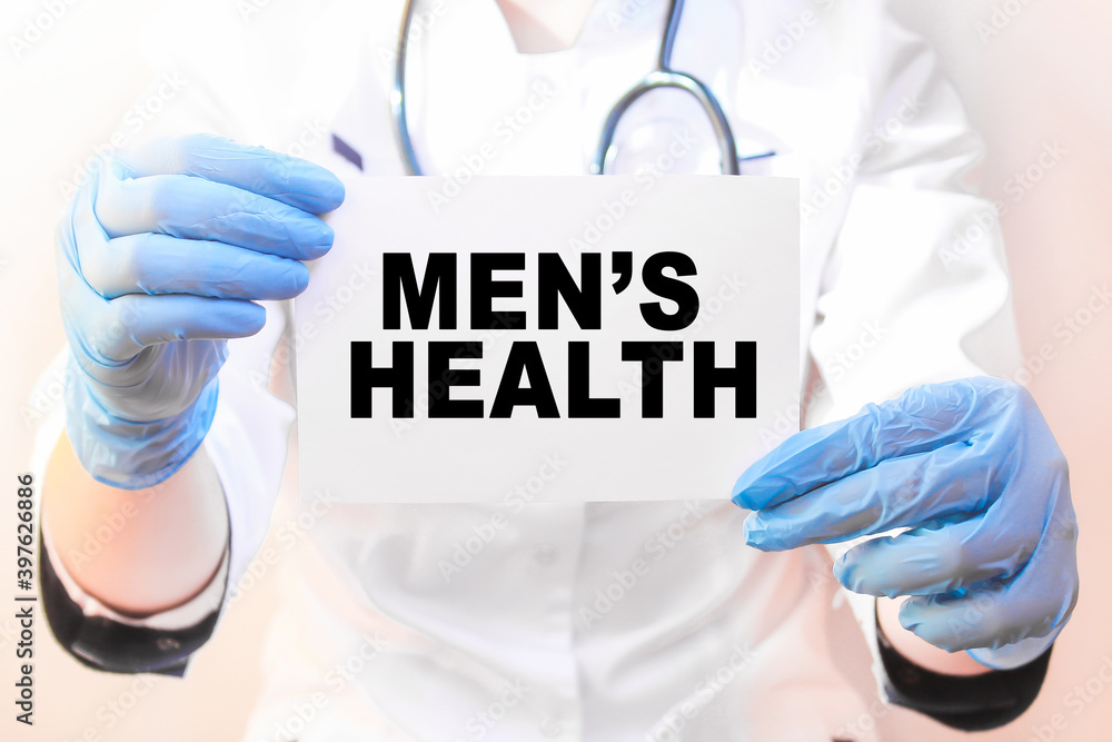 The doctor's blue - gloved hands show the word MEN'S HEALTH - . a gloved hand on a white background. Medical concept. the medicine The doctor's blue - gloved hands show the word MEN'S HEALTH - . a gloved hand on a white background. Medical concept. the medicine