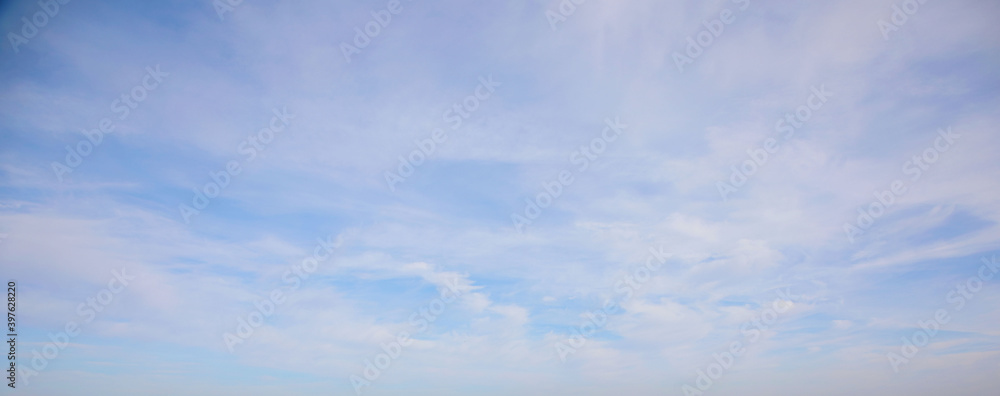 View of the blue sky with snow-white shells. Natural photo. Cloudy weather. For wallpaper, postcards and backgrounds.