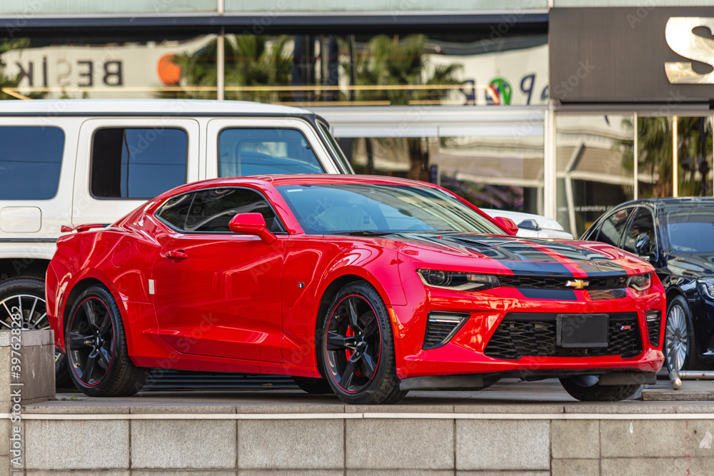 Red Chevrolet Camaro ZL1 supercharged muscle car with black stripe on the  hood. Side View, Besiktas, Turkey - Nov 17 2020 Stock-foto | Adobe Stock