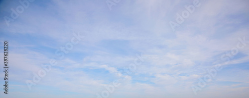 View of the blue sky with snow-white shells. Natural photo. Cloudy weather. For wallpaper, postcards and backgrounds.