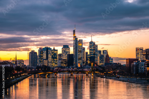 Frankfuert is the only skyline in Germany. backlit photography for sunset with a great sky and lighting in the houses. High-rise buildings, city recording and finance © Jan