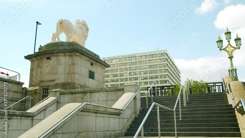 Lockdown in London, cinematic gimbal walk of a bird landing on a monument infront of St Thomas' Hospital with deserted streets, during the COVID-19 pandemic 2020. photo