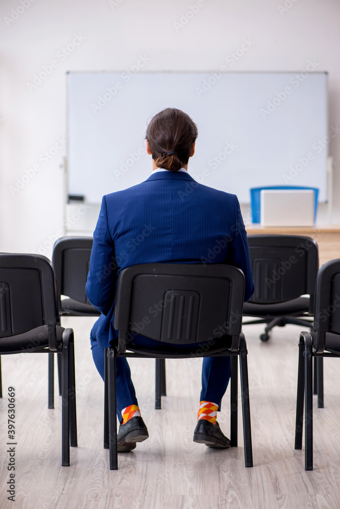 Young male business trainer in the office during pandemic Young male business trainer in the office during pandemic