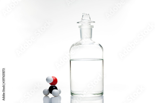 A bottle of methanol with its chemical structure. photo