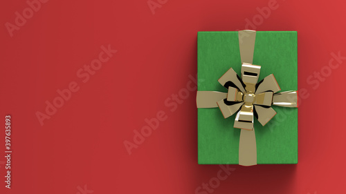Decorative green gift box with golden bow and ribbon. Red background . Copy space available for your content. Christmas gift box