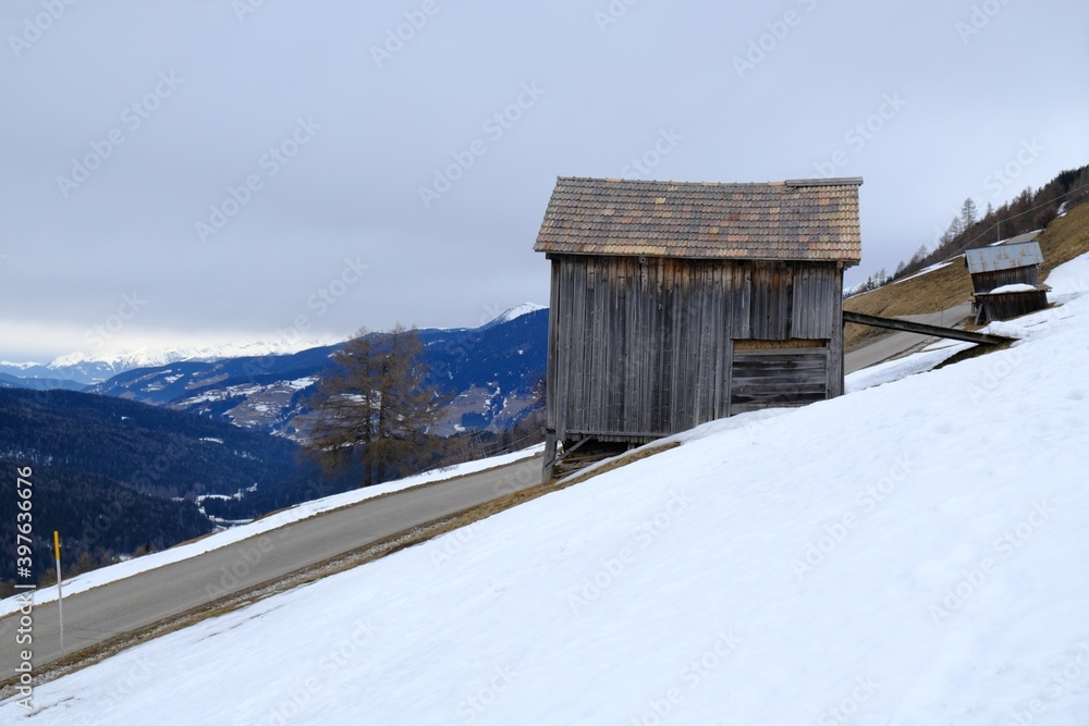 Winter mountain view with traditional wooden rural building from area around Monte Elmo/Helm in Dolomites, Italy, Puster Valley/Alta Pusteria, South Tyrol.