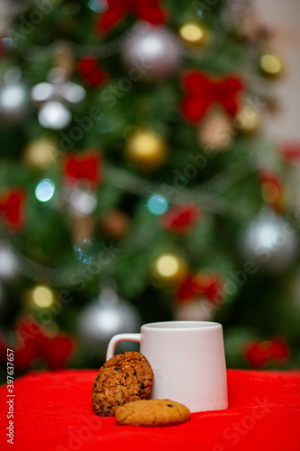 christmas drinks and cakes on background tree