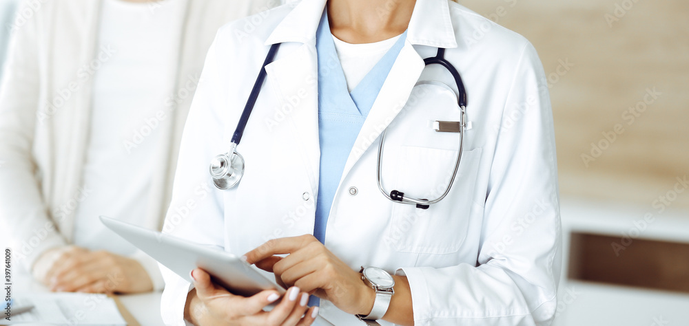 Unknown woman-doctor using tablet computer, close-up. Medicine concept Unknown woman-doctor using tablet computer, close-up. Medicine concept