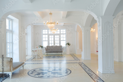 beautiful stylish chic rich clean bright blank interior. high white walls with large windows from floor the pattern on the floor
