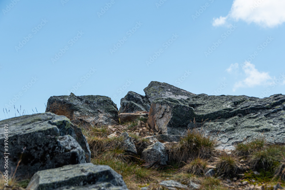 Boulders of ridge against sky. Rock climbing and mountain travel